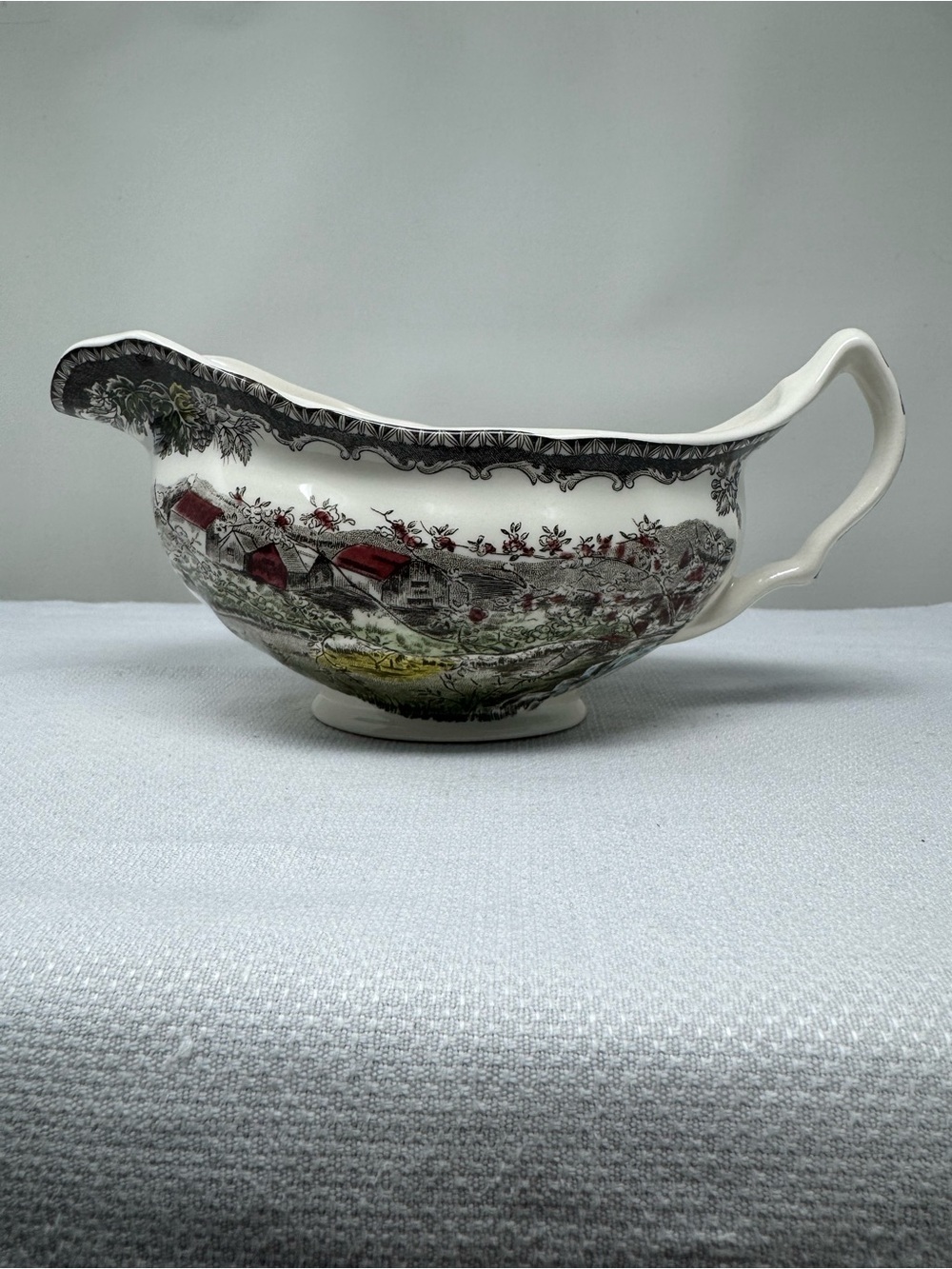 Ceramic gravy boat titled 'Friendly Village' by Johnson Brothers
